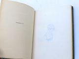 a person holding a book with a drawing on it