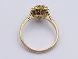 a close up of a yellow gold ring with a black diamond in the center