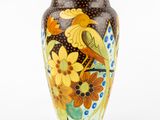 a vase with a bird and flowers painted on it