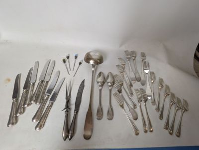 a lot of silver spoons and forks on the table