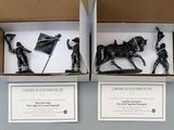 two boxes that have figurines of people in them