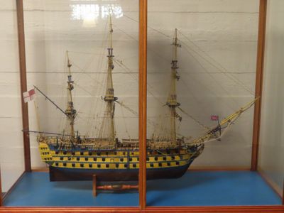 a display case with a model of a ship in it
