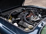 a blue car with a engine in the trunk of it