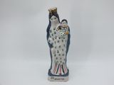 an image of a figurine of a woman holding a cat