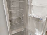 a white refrigerator with its door open on the floor