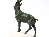 statue of a goat on a rock on a white background