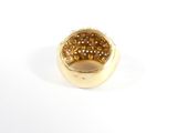 yellow gold ring with brown stones on a white background