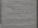 an old document with a red ribbon on it sitting on a table