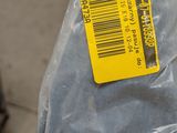 a plastic bag with a label on it sitting on the ground