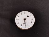a white clock with roman numerals on the face of it