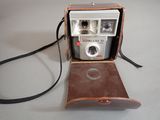 an old camera sitting in a case on a table