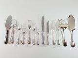 a lot of silverware on a table with a spoon and knife