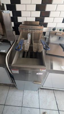 a picture of a commercial kitchen with two deep fryers