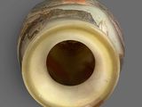 a close up of a vase with a hole in it