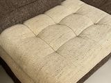 beige and brown upholstered couch with ottoman in a living room