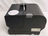 an image of a black printer sitting on top of a white table