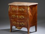 an antique chest of drawers with a marble top