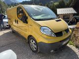 a yellow van parked in a parking lot with a mountain in the background