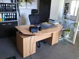 a desk with a chair and a laptop on it