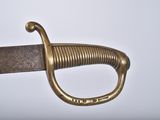 an image of a sword with a gold handle on a white background