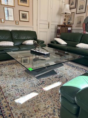 a man standing in a living room next to a couch