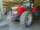 a red tractor that is parked in a garage