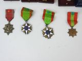 five medals on a table with a box of medals