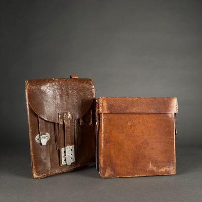 two pieces of brown leather luggage sitting next to each other