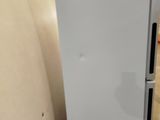 a white refrigerator that is sitting in a room