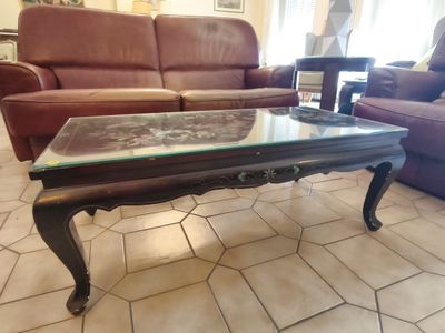 a coffee table with a glass top in a living room