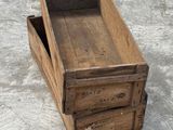a wooden box that is sitting on the ground