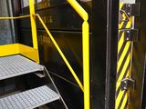 a black and yellow staircase going up to a building