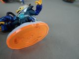 a toy that is laying on the ground with a frisbee