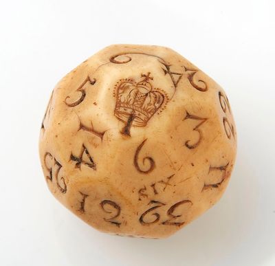 a wooden dice with numbers on it on a white surface