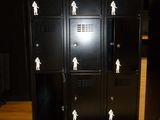 a bunch of black lockers with white stickers on them