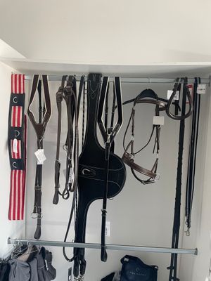 a picture of a horse ' s tacking room with a lot of tacking equipment