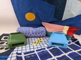 a blue and white blanket with a yellow dot on it and a blue and white blanket with a yellow dot on it and a blue and white and yellow