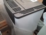 a small air conditioner sitting on a pallet in a room