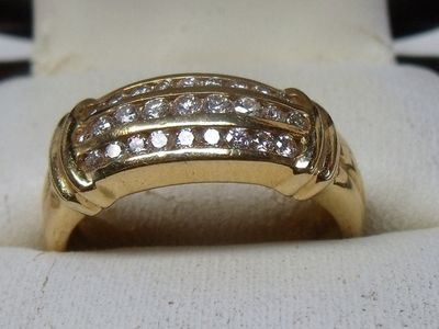 an image of a gold ring with diamonds on it