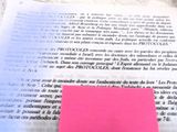 a pink post it on top of an open book