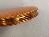 a gold pocket watch with a gold case on it
