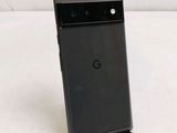 the back of a black google pixel phone sitting on top of a table