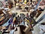 many pairs of shoes sitting on a table in a room