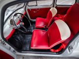 a red and white interior of a car with a steering wheel
