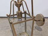 an image of a brass wall light with a clear glass shade