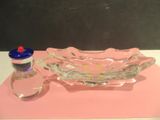 a glass bowl and a bottle of water on a table