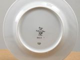 a white plate with a design on it sitting on a table