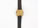 a close up of a watch on a white surface