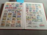 an open book with stamps on it sitting on a table