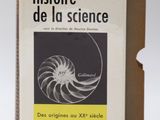 un livre ouvert posé sur une table à côté d'une boîte